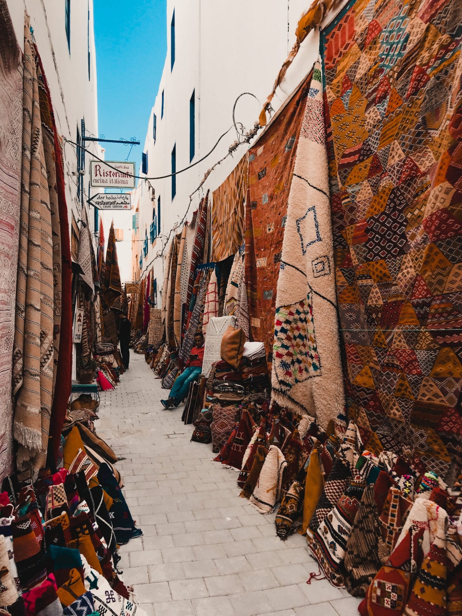 Rugs and textiles in an alleyway, Essaouira Morocco 